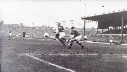 George McLeod is blocked off the ball by Stan Lynn