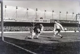 Allan Brown rushes in but Bert Trautmann has a hold on the ball