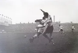Gordon Turner chases the ball after Mel Scott had cleared the ball away from Brian Whitby
