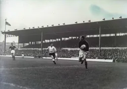 Leeds keeper Roy Wood has the ball in his hands as Allan Brown runs forward