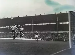 John Groves and Jack Charlton compete for a high ball. Allan Brown also leaps off the ground
