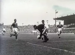 Allan Brown puts Roy Wood under pressure but he safely gathers the ball