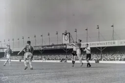 Graham Stanley heads the ball clear for Bolton with Billy Bingham and John Groves in close attendance