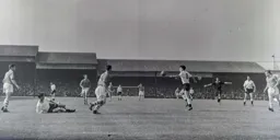 Gordon Turner looks to control the ball as the referee waves play on