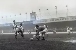 Rovers keeper Harry Leyland stoops to grab the ball away from Billy Bingham