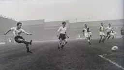 Billy Bingham plays the ball across the penalty area