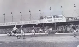 The ball drifts wide of the goal as Allan Brown looks on