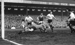 Eddie Hopkinson stops this attack led by Bob Morton