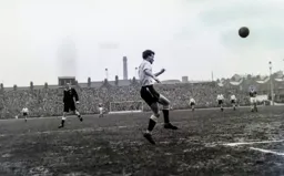 Billy Bingham heads the ball across the penalty area