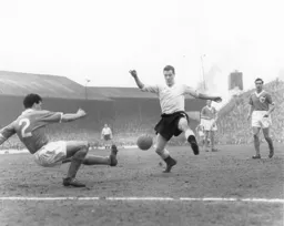 Allan Brown attempts to block Jimmy Armfield`s clearance