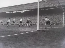 City keeper Sandy Kennon goes to dive on the ball before Allan Brown can react