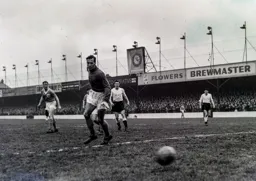 Allan Brown and Blackpool keeper George Farm watch as the ball goes wide of the goal