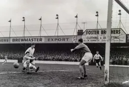 Some last ditch defending stops the ball from going through to John Kilgannon