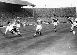 George Cummins falls as he takes a shot at goal