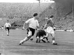 Brendan McNally covers as Ron Baynham gathers the ball