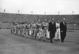 The two teams enter the field