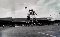 Billy Bingham puts pressure on Leeds defender Grenville Hair