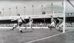 John Kilgannon and Leeds defender Jack Charlton watch the ball cleared