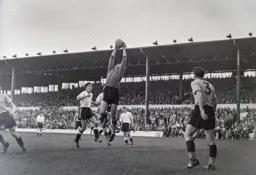 City goalkeeper Bert Trautmann safley catches the ball