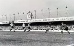 Ron Baynham fields a shot from Wolves forward Peter Broadbent