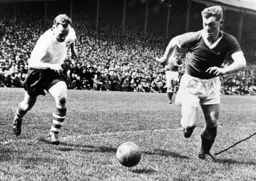 Alan Daniel in a race for the ball with Tom Finney who was playing his final game