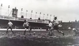Gordon Turner nets the third goal on a bog of a pitch
