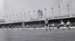 Jim Standen safely clutches the ball watched by the covering John Bramwell and Ron Cope