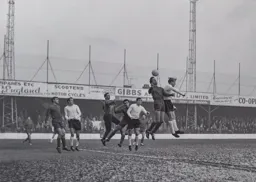 John Reid heads the ball into the danger area