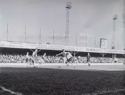Tommy McKechnie appears to be impeded by Vic Crowe