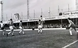 John Reid climbs to get his head to a cross from the left wing