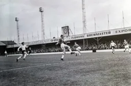 The ball is cleared as Billy Harber tries to intercept