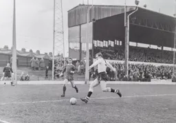 Fred Jardine looks to clear the ball as he is closed down by Jim Pennington