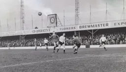 Colin Tinsley keeps his eye on the ball as Gordon Fincham and Ray Lancaster jostle for position