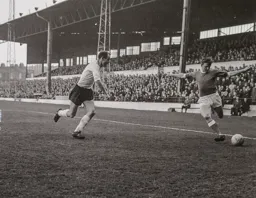 Robert Thomson moves in to tackle Dennis Fidler