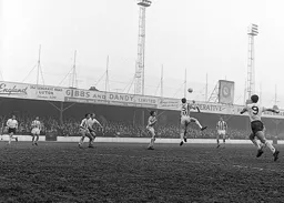 Mick Loughton heads the ball clear for United