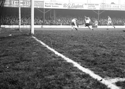 Tommy McKechnie stretches for the ball but Sandy Kennon has it safely under control