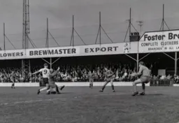 Alan Rivers tries to get a shot at goal under pressure from Peter Jones