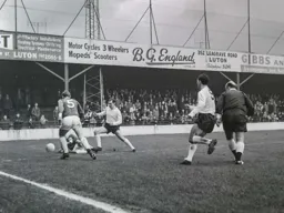 Graham French tussles for the ball watched by George Yardley and the referee