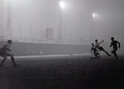Bruce Rioch is tackled before he can shoot as the fog and gloom descends