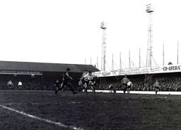 David Pleat ploughs through the mud to fire a shot at goal