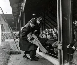 'Little Jim' being taken from the Oak Road crowd