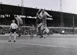 Keith Allen looks on as others compete for the ball