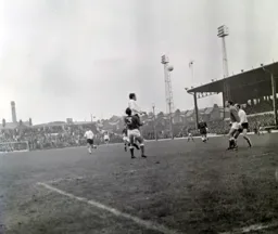 Graham French gets above Gerry Sears to head the ball across the penalty area