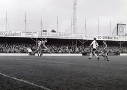 Clive Middlemass clears the ball away from Ian Buxton