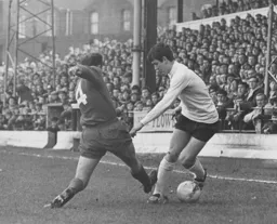 Bruce Rioch eludes a Workington defender