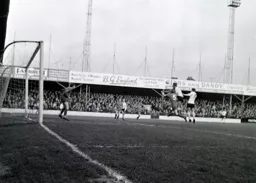 Keith Allen gets above Jim Tugman to direct a header at goal