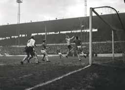 Keith Allen and John Hardie both go for the ball
