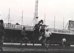 Terry Branston sends a header towards the goal