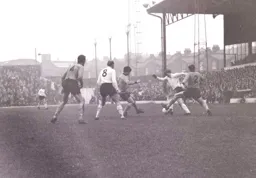 Bruce Rioch gets past Joe Wilson`s lunging tackle
