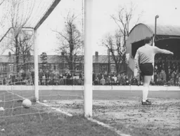 The Darlington goalkeeper Tony Moor directing his wall as the ball nestles in the net